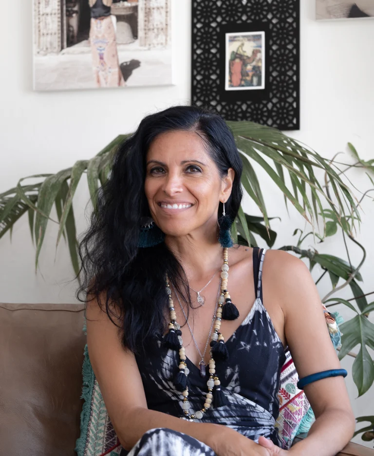 Veronica Galipo, life coach and self-love guide, relaxed at home in her lounge.
