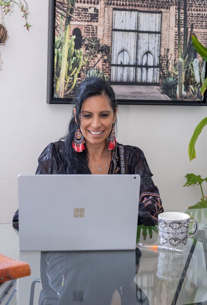 Veronica Galipo, life coach and self-love guide, is listening closely to a client during a coaching session at home.