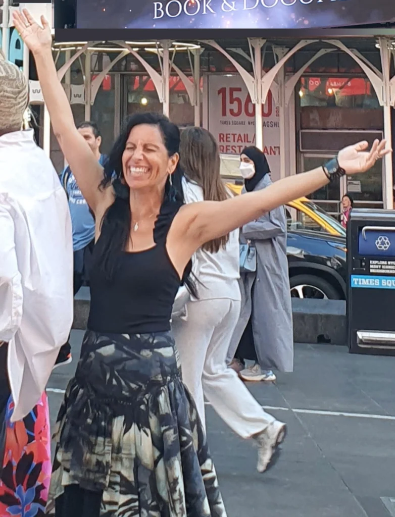 Veronica Galipo, life coach and self-love guide, is celebrating in Times Square, New York, as her book series appears on the digital billboard.